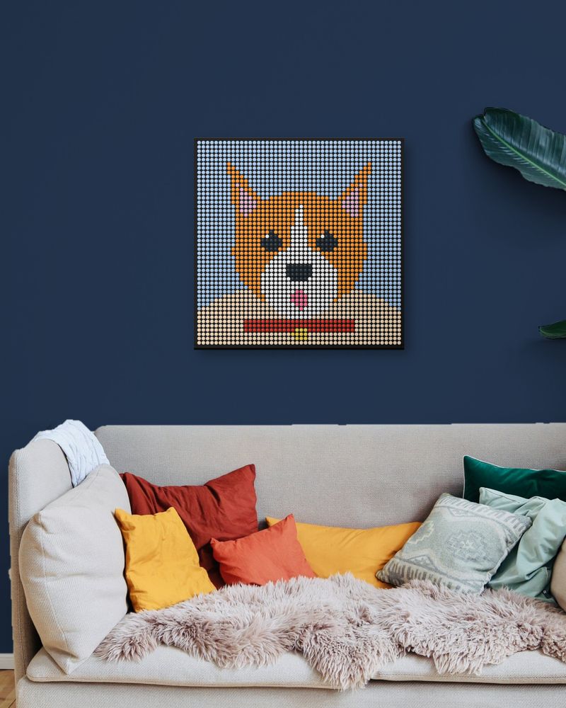 A corgi portrait mosaic hanging above a sofa on a navy wall