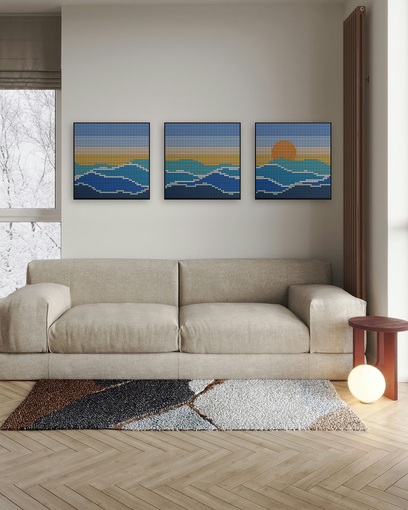 Three ocean wave mosaics hung in a row above a beige sofa
